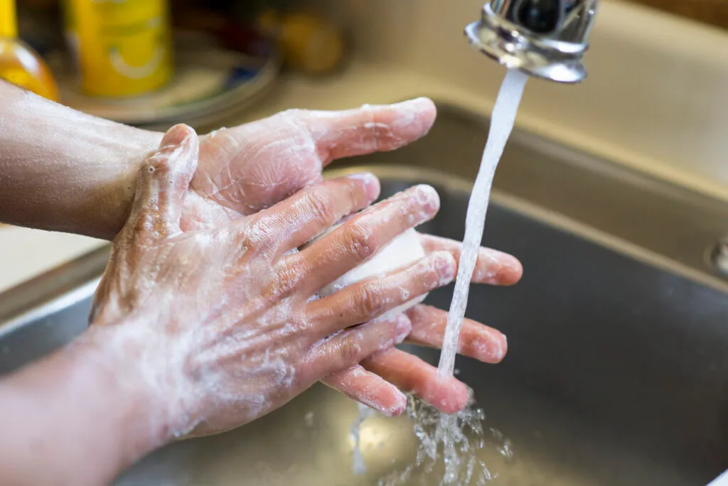 person with ocd washing their hands.