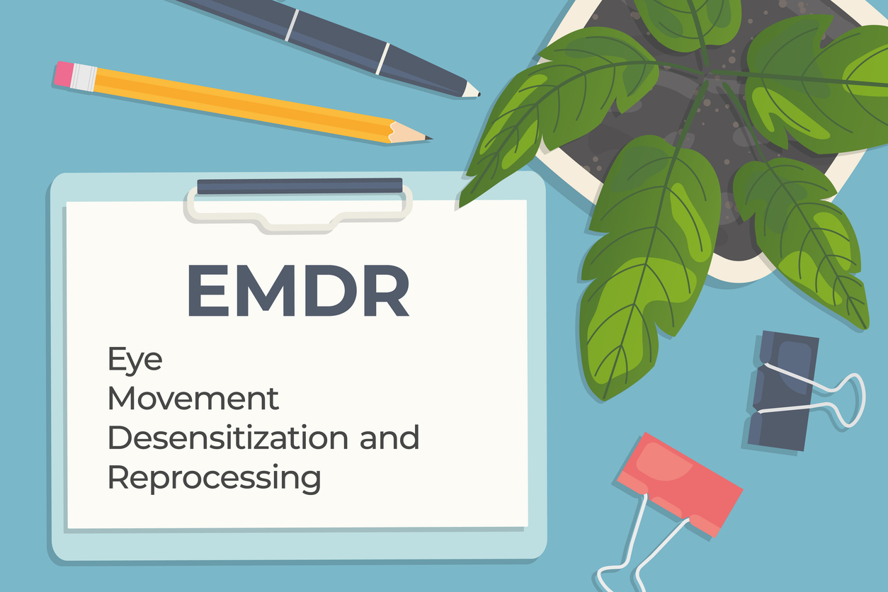 EMDR (Eye Movement Desensitization and Reprocessing) therapy written on clipboard, flat lay composition